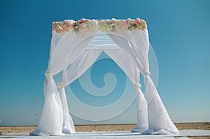 Wedding white arch on the beach.