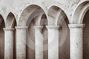 White arches with columns in temple medieval door.