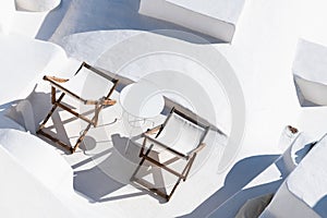 White architecture in Santorini island, Greece. Chaise lounges on the terrace with sea view
