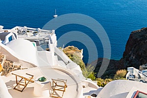 White architecture in Santorini island, Greece. Two chaise lounges on the terrace with sea view