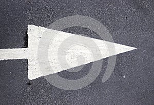 White arrow on black tarmac