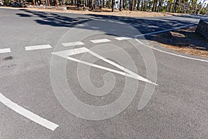 White Arrow direction on a asphalt road