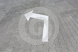White arrow down on street tile