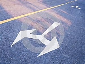 White arrow sign on the road, Junction turn left and turn right