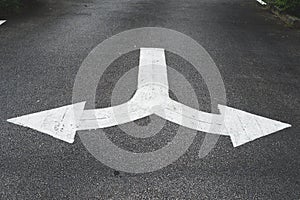 White arrow symbols pointing left and right give directions on the road