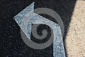 The white arrow turns left on the road surface
