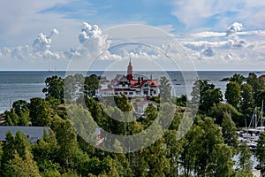 White Art Nouveau style villa located on a small green Luoto island