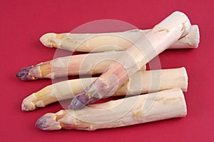 White asparagus close up on red background