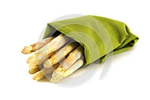 White asparagus, fresh from the market in a green towel isolated