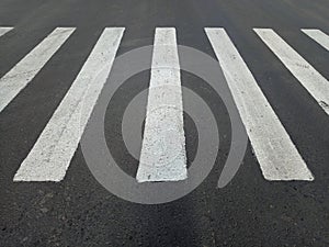 White asphalt crosswalk lines