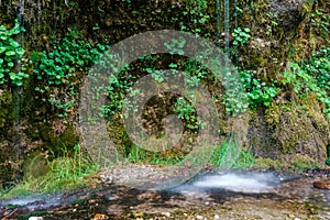 white atomized water from dripping water through overhanging conglomerate named rinnende mauer in a canyon