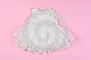 White baby dress on a pink background