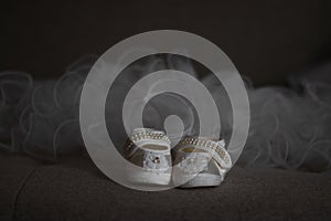 White baby girl shoes with lace flower and beaded straps and raffled tulle at the back