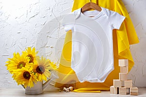 White baby short sleeve bodysuit mockup with sunflowers and wooden toys