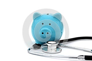 On a white background is a blue piggy bank and a stethoscope.