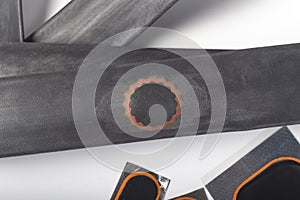 on white background. The camera from the bicycle on it is a patch of raw rubber. Close-up