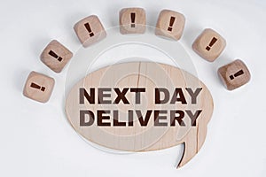 On a white background, cubes with an exclamation mark and a sign - thoughts with the inscription - NEXT DAY DELIVERY