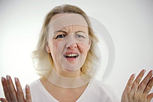 white background disgruntled woman raised Hands Up Seriously mouth is open press forehead furrowed eyebrows and anger of