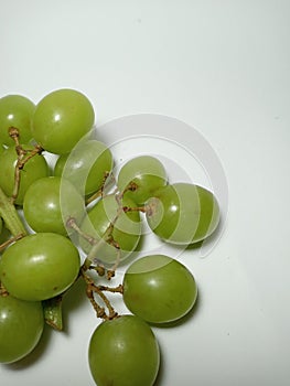 White background with fresh green grape, Vitis vinifera L.