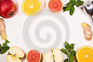 On a white background fruit and citrus vitamin A set of apples, grapefruit, orange, ginger, mint Healthy eating