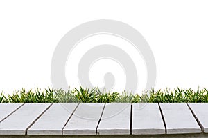 White background and grass on a white wood floor.