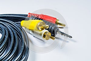 On white background hank of black cables with multi-colored plugs  tulip. Technologies. A multimedia wire for TV.