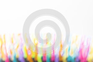 White background image with multicoloured blurred flame shapes across the bottom.