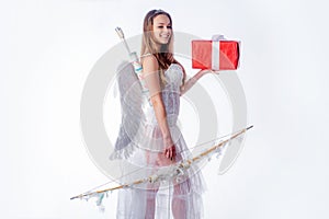 White background isolated. Cupid in valentine day. Girl dressed as an angel on a light background. Portrait of a cupid