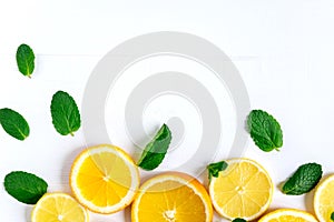 White background with lemon, orange slices and mint. Concept with fresh fruit. Lemon, Orange, Mint. View from above