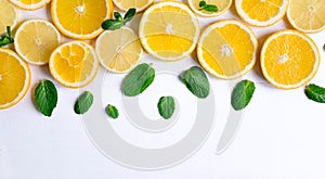 White background with lemon, orange slices and mint. Concept with fresh fruit. Lemon, Orange, Mint. View from above