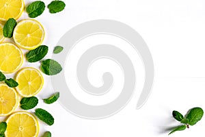 White background with lemon, orange slices and mint. Concept with fresh fruit. Lemon, Orange, Mint. View from above