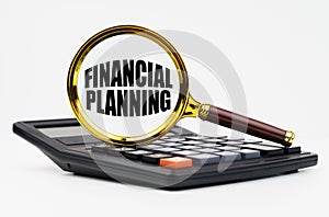 On a white background lies a calculator and a magnifying glass with the inscription - Financial planning