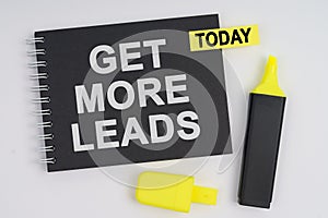 On a white background lies a marker and a notebook with a TODAY sticker and the inscription - GET MORE LEADS