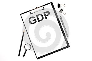 On a white background magnifier, a pen and a sheet of paper with the text GDP Business concept