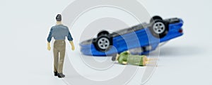 On a white background, a man who is walking towards a car overturned as a result of an accident and a woman lying down