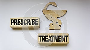 medication icon and wooden blocks with the text Prescribe treatment photo