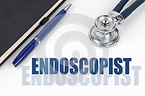 On a white background, a notepad and a stethoscope, next to a double inscription - ENDOSCOPIST