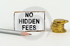 On a white background, a pencil, coins and a sign with the inscription - No hidden fees