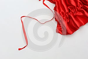 white background with a piece of satin fabric and satin ribbon