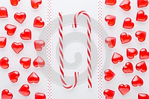 White background with red hearts and christmas candy cane