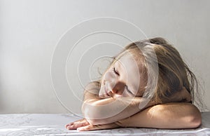 On a white background a sleeping smiling girl lies in the rays of the sun morning copy space
