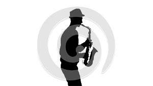 White background in studio. Silhouette jazzman performs solo on saxophone