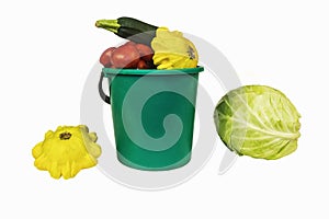 On a white background there is a bucket of vegetables