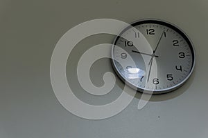 White background wall clock in the dark