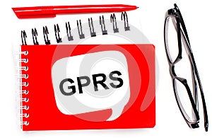 On a white background, white and red notepads, black glasses, a red pen and a white card with the text GPRS General Packet Radio