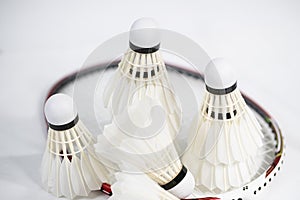 White badminton shuttlecocks lay on white table background