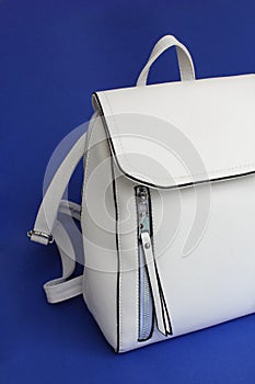 White bag backpack on a blue background photo