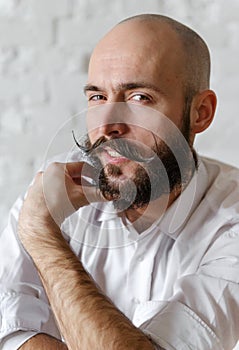 White bald man with a beard and mustache in a white shirt, young, 30 years old