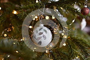 White ball and Christmas toys hanging on the tree