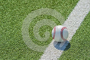 White ball for playing baseball on the grass background